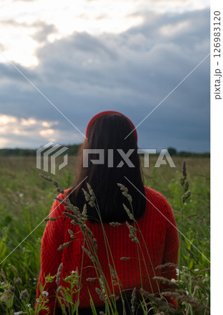 Woman in Red Sweater in Grassy Field 126983120
