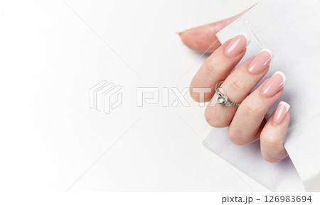 Woman hand showing french manicure and elegant ring on white background 126983694