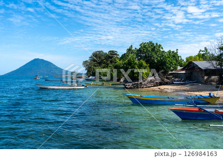 Small port on Bunaken Island Sulawesi Indonesia with volcano view 126984163