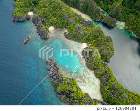 Kayaks over clear turquoise water in Small Lagoon in Miniloc Island. El Nido, Palawan. Philippines. 126984281