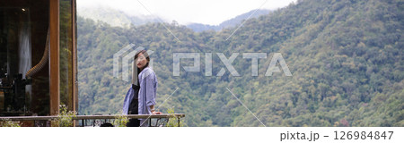 digital nomad concept asian freelancer woman relax and outdoor work at mountain view of coffeeshop 126984847