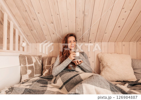 Happy Woman Drinking Morning Coffee in Bed 126984887