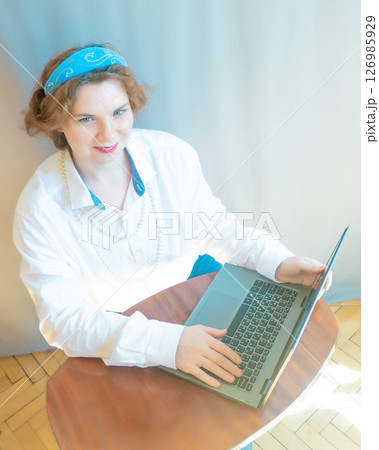 modern woman with elements of ethno-style in a costume uses the technique 126985929