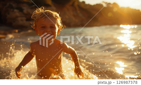 Joyful child in splashes of sea water. 126987378