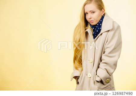 Woman wearing autumnal beige coat Woman wearing autumnal beige coat 126987490