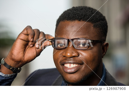 Elegant man in glasses outdoors. 126987908