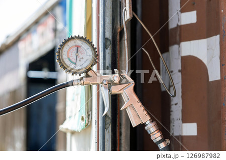 Old tire pressure gauge, tire fitting, car service Old tire pressure gauge, tire fitting, car service 126987982