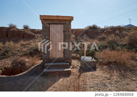 Countryside outdoor restroom. Cinderblock toilet cabin Countryside outdoor restroom. Cinderblock toilet cabin 126988008