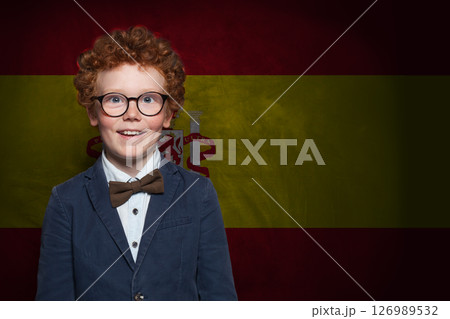 Smart schoolboy child on Spanish flag background. Education and childhood in Spain concept 126989532