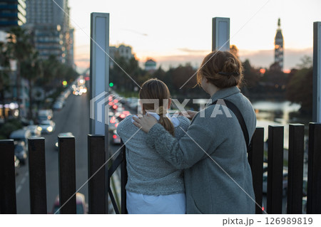Back of woman and young girl child looking at city street. Childhood, happiness, vacation 126989819