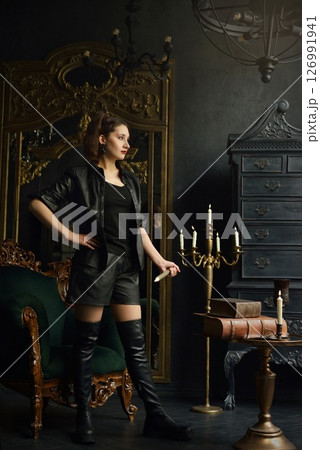A young girl with dark hair poses as Buffy the vampire hunter A young girl with dark hair poses as Buffy the vampire hunter 126991941