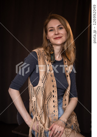 A young girl poses in a boho style suede vest. A young girl poses in a boho style suede vest. 126992049