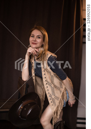 A young girl poses in a boho style suede vest. 126992058