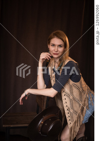 A young girl poses in a boho style suede vest. A young girl poses in a boho style suede vest. 126992060