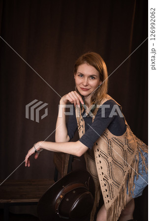 A young girl poses in a boho style suede vest. 126992062