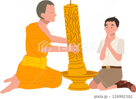 A young Thai student offers a candle to a monk during Khao Phansa at a temple 126992382