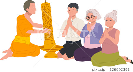 Elderly woman and grandchild offer a candle to a monk during a buddhist holiday. Buddhist Lent Elderly woman and grandchild offer a candle to a monk during a buddhist holiday. Buddhist Lent 126992391