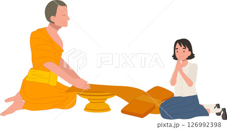 A Thai student girl offers a bathing robe to a monk during Buddhist Lent A Thai student girl offers a bathing robe to a monk during Buddhist Lent 126992398