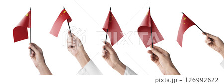 The China flag in hand in different angles on a white background 126992622