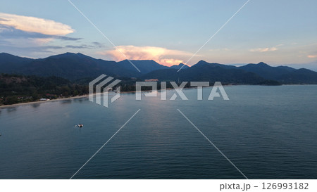 Serene coastal landscape at sunset with mountains Serene coastal landscape at sunset with mountains 126993182