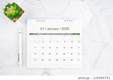 Desk calendar on month of January 2026 with pen on white marble background. 126994741