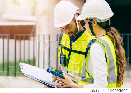 Construction Engineer team, Engineers teamwork man and women working together at construction site 126995065