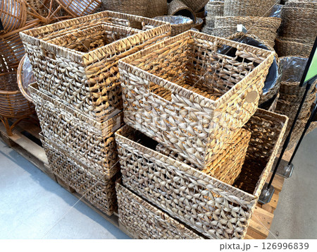 Various woven basket on shelves indoors 126996839