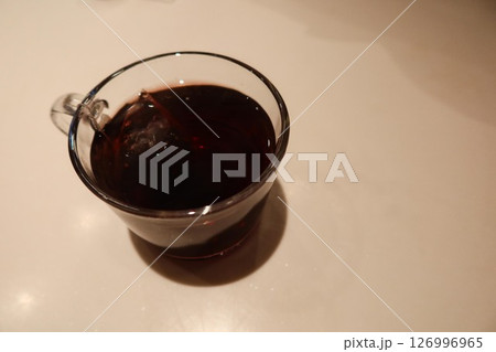 close up of top shot of hot black coffee in a glass with copy space in a white marble table 126996965