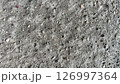 Surface texture of concrete showing various stones and pebbles 126997364