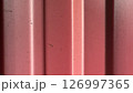 Red texture with vertical lines and subtle imperfections in sunlight 126997365