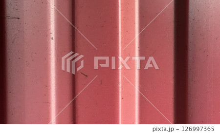 Red texture with vertical lines and subtle imperfections in sunlight Red texture with vertical lines and subtle imperfections in sunlight 126997365
