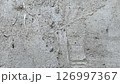 Concrete wall with rough texture and subtle markings in urban setting 126997367