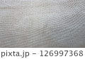 Textured fabric surface in neutral tones is displayed prominently 126997368