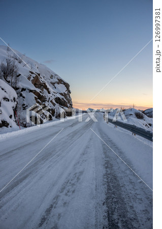 Snowy road up a hill, Norway 126997381