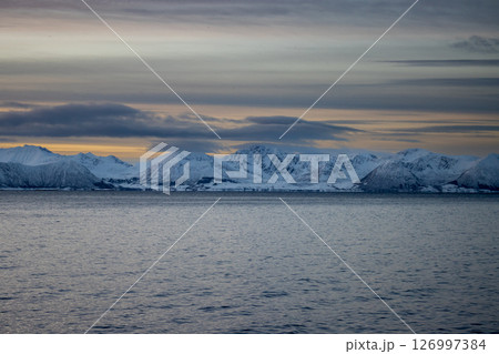 Sea and snowy mountains in the sunset, Norway 126997384