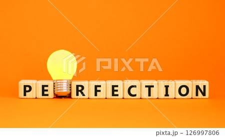 Perfection symbol. Concept word Perfection on beautiful wooden blocks. Beautiful orange table orange background. Yellow light bulb. Business perfection concept. Copy space. Perfection symbol. Concept word Perfection on beautiful wooden blocks. Beautiful orange table orange background. Yellow light bulb. Business perfection concept. Copy space. 126997806