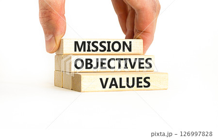 Mission objectives values symbol. Concept words Mission Objectives Values on beautiful blocks. Beautiful white background. Businessman hand. Business mission objectives values concept. Copy space. 126997828
