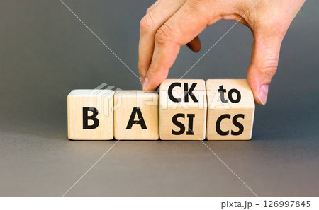 Back to basics symbol. Concept words Back to basics on wooden block. Beautiful grey table grey background. Businessman hand. Business back to basics concept. Copy space. 126997845