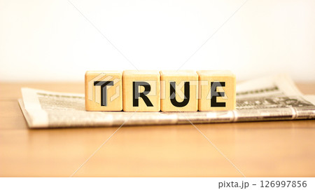 True symbol. Concept word True on beautiful wooden blocks on newspaper. Beautiful wooden table white background. Business, lifestyle, support and true concept. Copy space. True symbol. Concept word True on beautiful wooden blocks on newspaper. Beautiful wooden table white background. Business, lifestyle, support and true concept. Copy space. 126997856