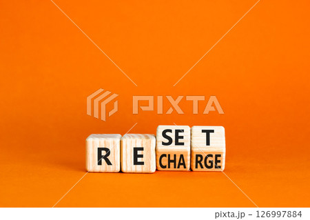 Reset and recharge symbol. Concept words Reset Recharge on beautiful wooden block. Beautiful orange table orange background. Business reset and recharge concept. Copy space. 126997884