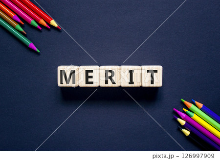 Merit symbol. Concept word Merit on beautiful wooden blocks. Beautiful black table black background. Beautiful colored pencils. Business lifestyle merit concept. Copy space. Merit symbol. Concept word Merit on beautiful wooden blocks. Beautiful black table black background. Beautiful colored pencils. Business lifestyle merit concept. Copy space. 126997909