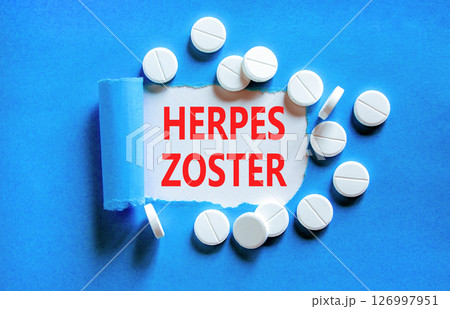 Herpes zoster symbol. Concept words Herpes zoster on beautiful white paper. White pills tablets. Beautiful blue background. Medical healthy lifestyle herpes zoster concept. 126997951