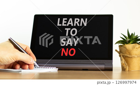 Learn to say no symbol. Concept words phrase Learn to say no on beautiful black tablet. Businessman's hand. Beautiful white background. Business psychological Learn to say no concept. Copy space. Learn to say no symbol. Concept words phrase Learn to say no on beautiful black tablet. Businessman's hand. Beautiful white background. Business psychological Learn to say no concept. Copy space. 126997974