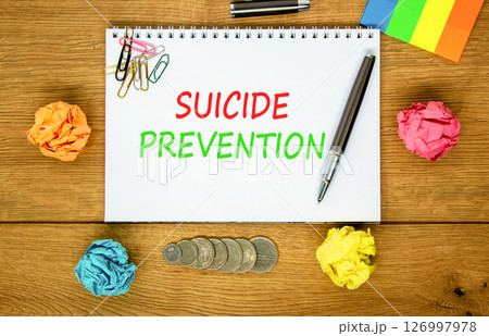 Suicide prevention symbol. Concept words Suicide prevention on beautiful white note. Beautiful wooden table wooden background. Black pen. Psychological suicide prevention concept. Copy space. 126997978