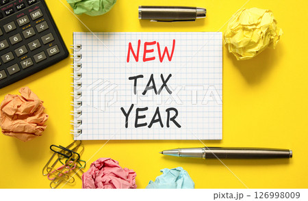New tax year symbol. Concept words New tax year on beautiful white note. Beautiful yellow background. Black pen. Black calculator. Business new tax year concept. Copy space. New tax year symbol. Concept words New tax year on beautiful white note. Beautiful yellow background. Black pen. Black calculator. Business new tax year concept. Copy space. 126998009