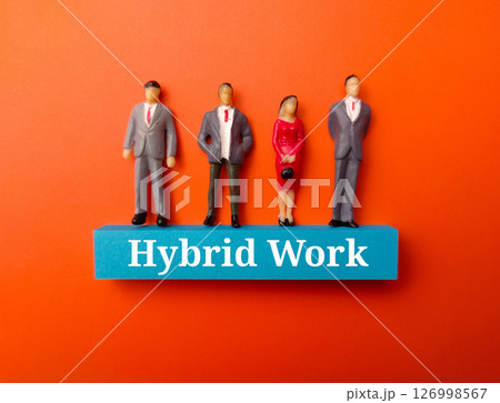 Miniature people with the word Hybrid Work on a orange background. Miniature people with the word Hybrid Work on a orange background. 126998567