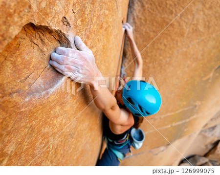 Rock Climber Scales Vertical Cliff in Outdoor Adventure During Bright Sunny Day 126999075