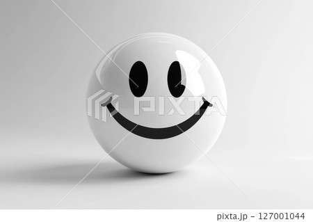 White smiling ball with a black face displayed on a soft background in an indoor setting during daylight, creating a cheerful atmosphere for any room 127001044