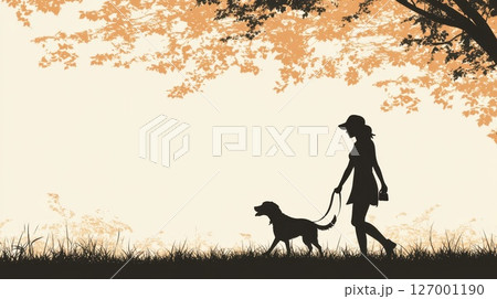 Silhouette of a woman walking her dog in a park during sunset 127001190