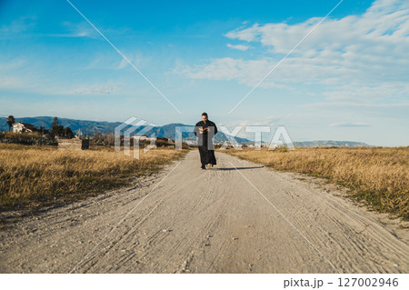 Monk With The Bible Following The Road Of God Monk With The Bible Following The Road Of God 127002946